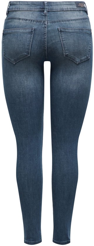 Donkerblauwe skinny jeans met middelhoge taille, lichte wassing, gezien van achteren.