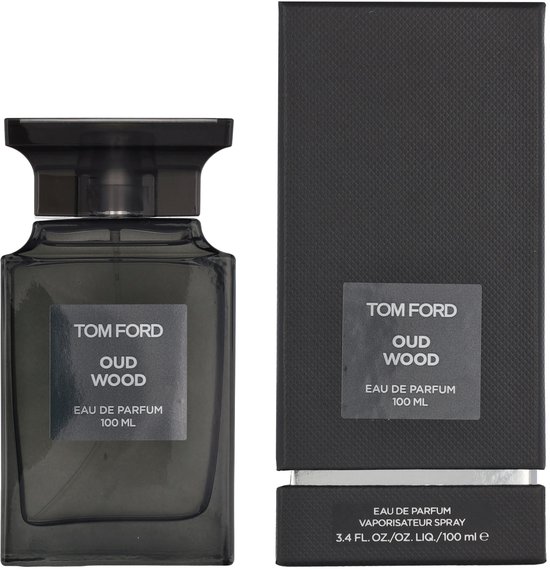Tom Ford Oud Wood Eau de Parfum 100 ml flacon naast de kartonnen verpakking.