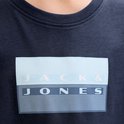 Close-up van de "JACK & JONES" opdruk op een donkerblauw T-shirt.