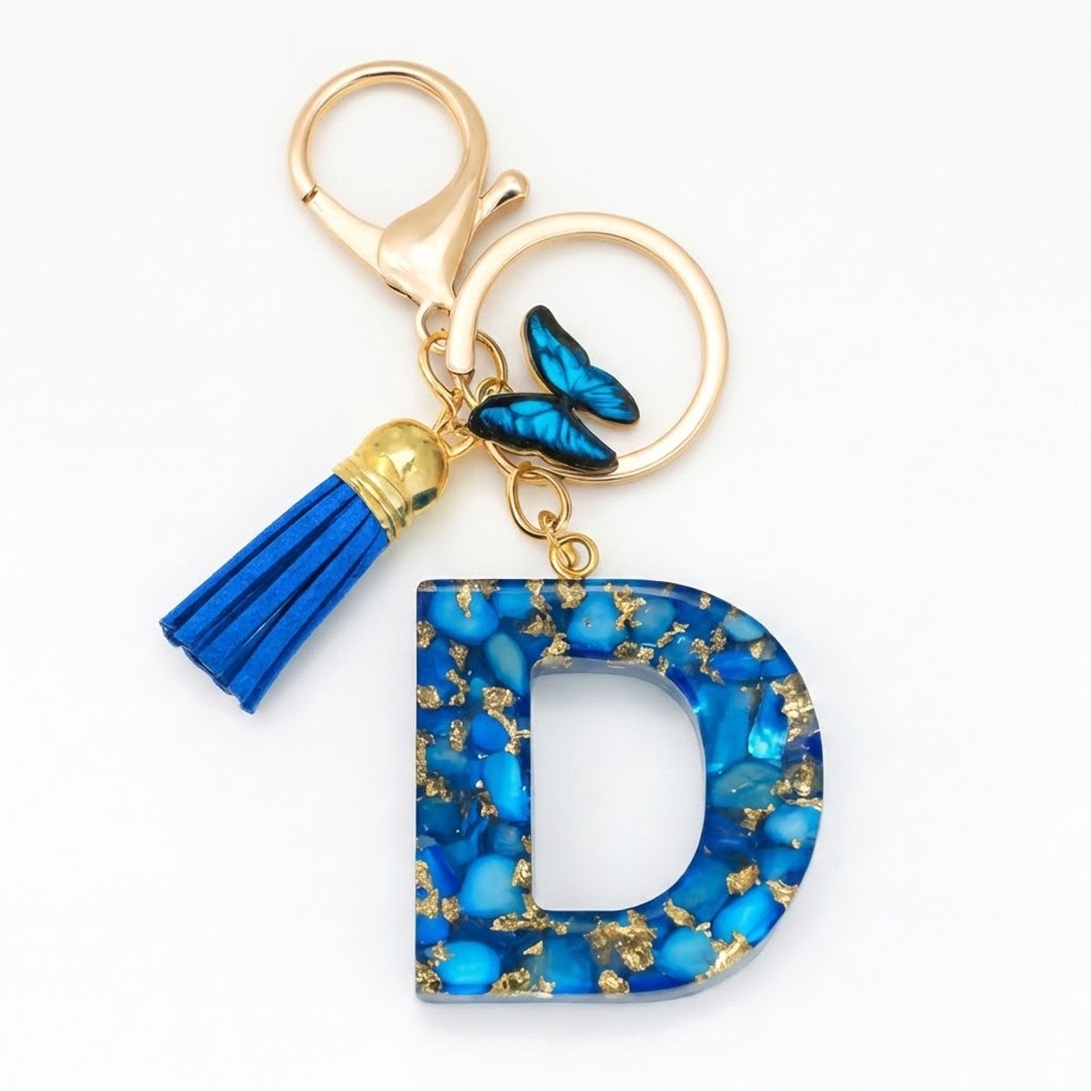 Blauwe letter D sleutelhanger met kwastje en vlinder – sleutelhanger voor dames – goudkleurige metalen keychain met acryl initiaal D hanger, decoratieve bedel en tassel