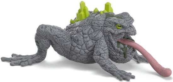 Crapaud de pierre gris avec des cristaux verts, une langue rose tendue et des dents.