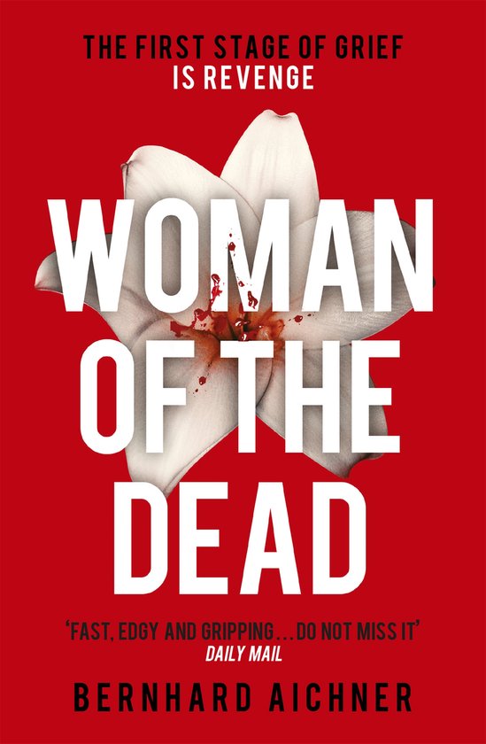 Boekomslag met de titel 'WOMAN OF THE DEAD' en een witte bloem op een rode achtergrond. Tekst: 'THE FIRST STAGE OF GRIEF IS REVENGE'.