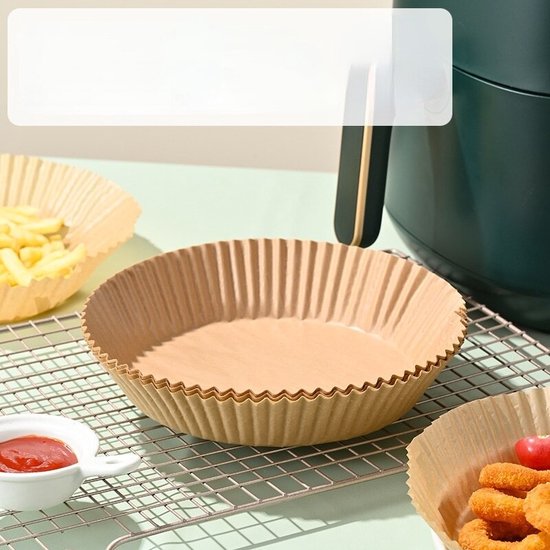 Bruine papieren airfryer bakvormpjes met gekartelde randen op een rooster.