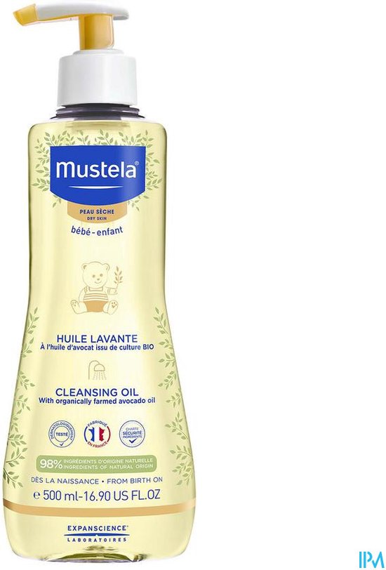 Fles Mustela doucheolie met gele pompdispenser. Het etiket toont een teddybeer en de tekst 'PEAU SECHE DRY SKIN'.