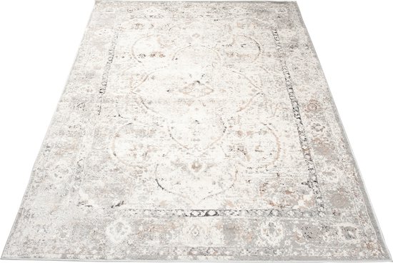 Un tapis vintage beige clair avec un motif détaillé dans des tons gris et marron.