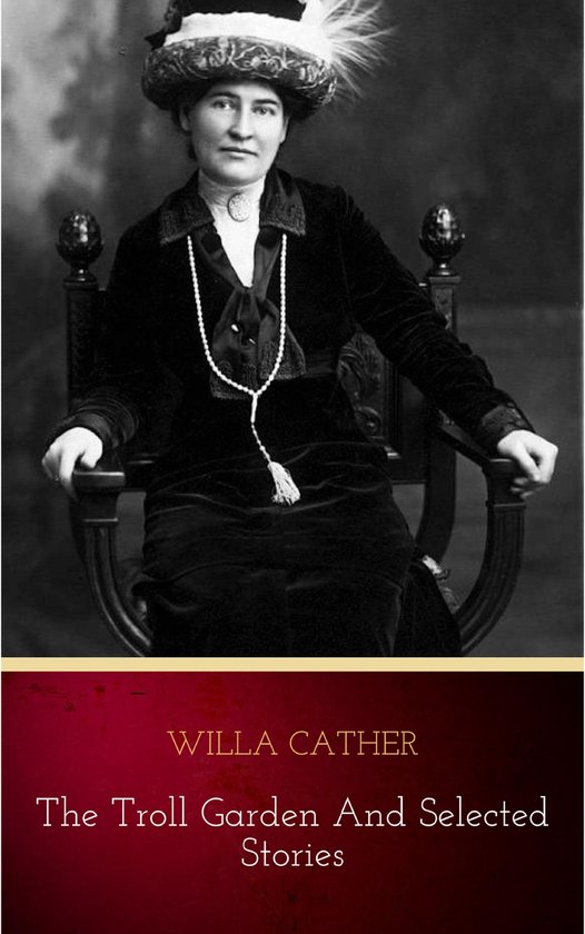 Een zwart-wit foto van Willa Cather zittend in een stoel, met een opzichtige hoed en een parelketting.