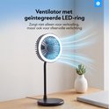 Zwarte tafelventilator met LED-ring die zowel verkoeling als sfeerverlichting biedt.