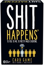 Zwarte speldoos met de tekst 'SHIT HAPPENS' in grote witte letters. Daaronder 'TO YOU. TO ME. TO PRETTY MUCH EVERYONE.' en een rij gele poppetjes, waarvan één nat regent.
