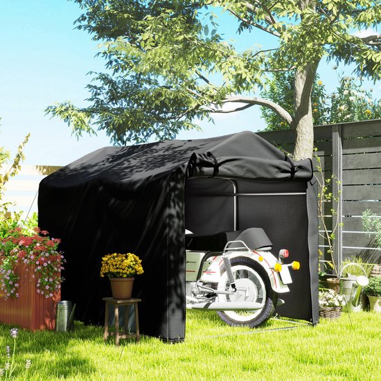 Zwarte tentgarage met motorfiets erin, staand op gras.