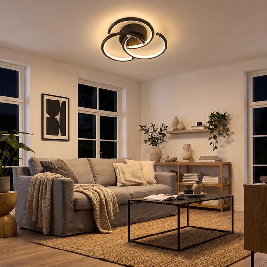 Moderne zwarte plafondlamp met drie ringen in een stijlvolle woonkamer.