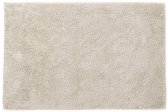 Een zandkleurige, pluizige badmat van 60 x 90 cm met antislip onderkant, uit de Casilin collectie.