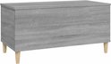 Grijze salontafel met houtnerf, gesloten, op houten pootjes, zijaanzicht.