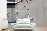 Behang - Fotobehang - Bovenaanzicht van een vliegtuig in de luchthaven. - Breedte 525 cm x hoogte 350 cm