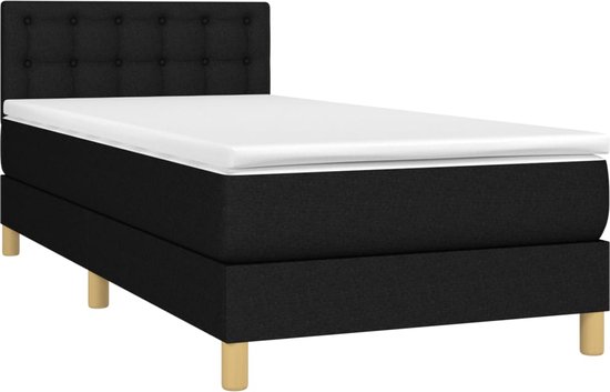 Lit boxspring noir avec tête de lit rembourrée, matelas et pieds en bois.