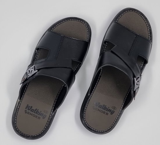 Paar zwarte slippers met gespen, 'Walking Shoes' op de binnenzool en wit stiksel.