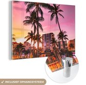MuchoWow® Glasschilderij 90x60 cm - Schilderij acrylglas - South Beach met palmbomen en een gekleurde lucht - Foto op glas - Schilderijen