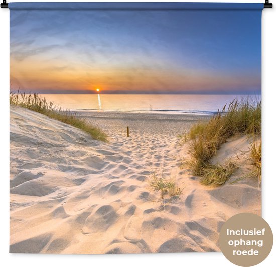Wandkleed met een zonsondergang bij de duinen, inclusief tekst 'Inclusief ophang roede' in een cirkel.