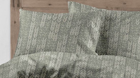 Taies d'oreiller avec un motif de feuilles tricotées vertes.
