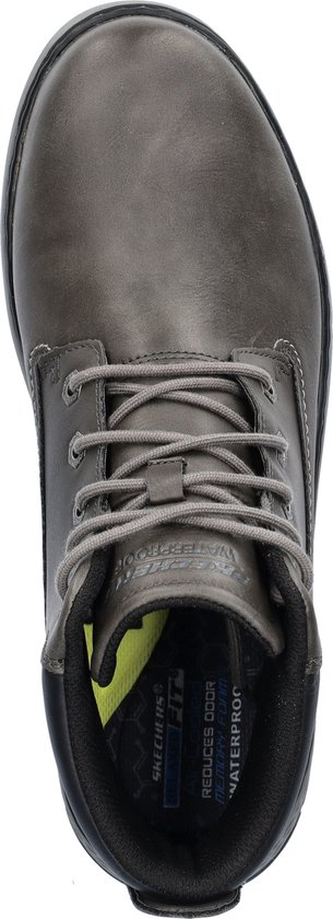 Binnenzicht van een donkergrijze veterschoen met 'WATERPROOF'-opschrift en gele binnenzool.