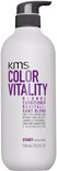 Witte KMS Color Vitality Blonde Conditioner fles met grijze pompdispenser en granaatappel-icoon.