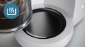 Gros plan de la plaque chauffante d'une cafetière Philips blanche avec une icône de vapeur.