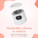 Witte flesverwarmer met deksel eraf. Digitaal display met temperatuur. "Makkelijk schoon te maken. Haal het makkelijk uit elkaar voor eenvoudige reiniging".