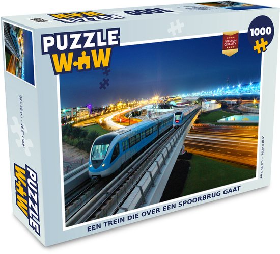 Boîte d'un puzzle de 1000 pièces, montrant un train de métro bleu roulant la nuit sur un pont ferroviaire éclairé.