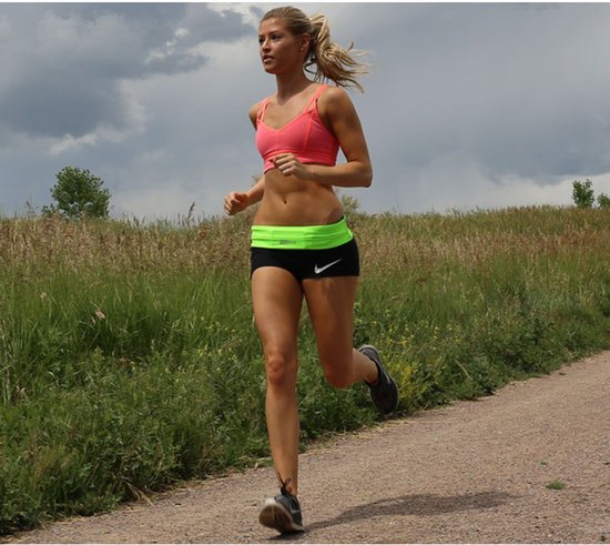 Vrouw met blonde paardenstaart in neonroze sportbeha en zwarte hardloopbroek met neongroene tailleband met Nike logo.