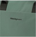 Close-up van het zwarte Hedgren logo op een groene, textuurstof rugzak.