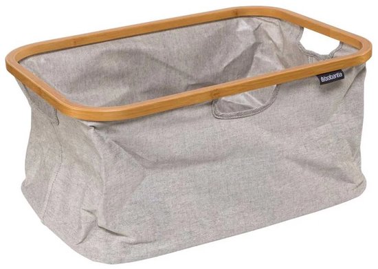 Grijze Brabantia wasmand met een bamboe frame en handvatten.