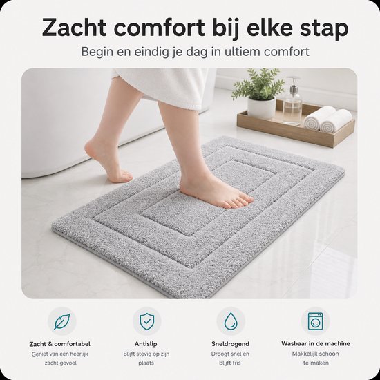Grijze badmat naast een bad met een voet erop, biedt zacht comfort.