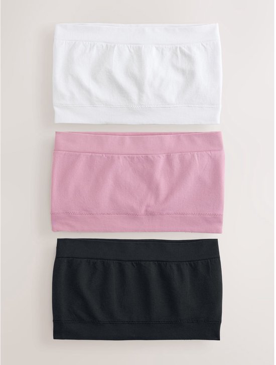 Drie naadloze bandeau-bh's in wit, roze en zwart.