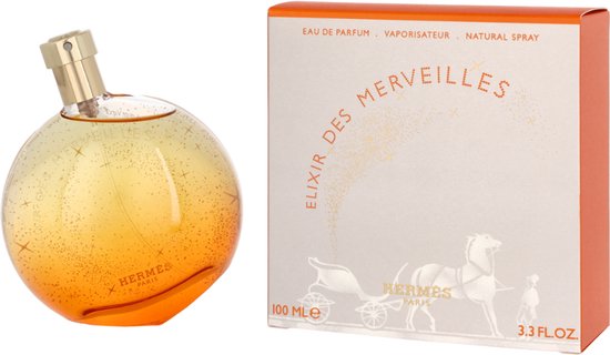 Elixir des Merveilles Eau de Parfum, 100 ml (3.3 FL.OZ). Doos met koets en parfumflesje, oranje-wit.