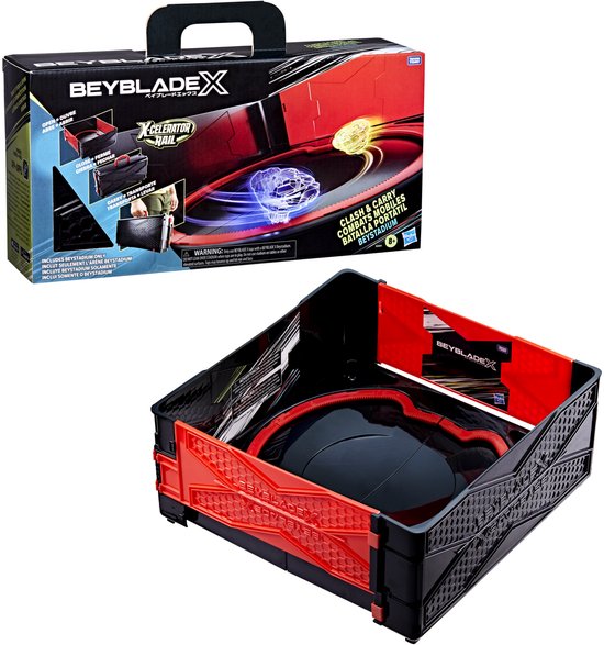 Zwarte Beyblade X arena met rode accenten, geopend en met de doos ernaast.