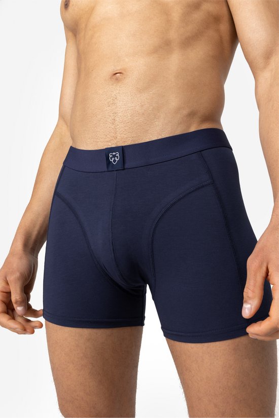 Man met donkerblauwe boxershort, gedragen door een donkergetinte man.