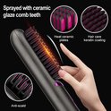 Grijze haarstyler met roze tanden en keramische platen, detail van de 'anti-scald' functie.