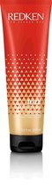 Een rode tube met gouden geometrische driehoeken, tekst 'REDKEN frizz dismiss rebel tame leave-in smoothing control cream heat protection'.