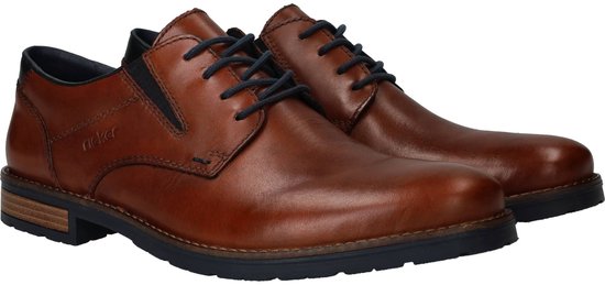 Bruine leren Rieker veterschoenen met donkerblauwe veters en accenten. De schoenen hebben een blokhak.