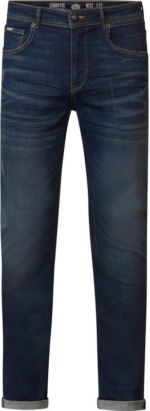 Donkerblauwe spijkerbroek met stonewash wassing, gele stiksels en opgerolde pijpen.