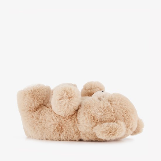 Beige teddy pantoffel, van de zijkant gezien, op zijn rug liggend.