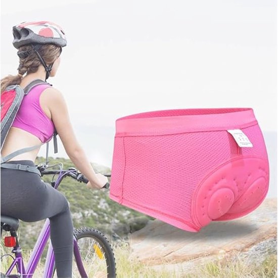 Culotte de cyclisme rose avec rembourrage 3D, portée par une femme à vélo.