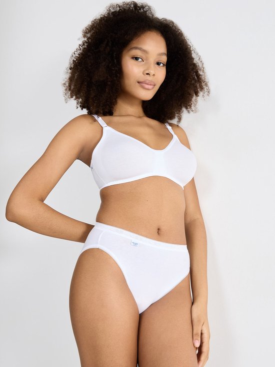 Model met een witte, beugelloze bh en bijpassende slip. Ze draagt het haar los.