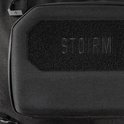 Zwarte voorzak van een rugzak met 'STORM' logo op een klittenbandpatch.