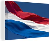 Canvas Schilderij Nederlandse vlag die in de wind wappert - 90x60 cm - Wanddecoratie