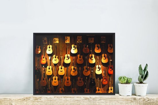 Affiche avec cadre Beaucoup de guitares acoustiques accrochées au mur - 30x20 cm