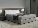 Un lit double avec linge de lit gris, draps gris foncé et coussins décoratifs.