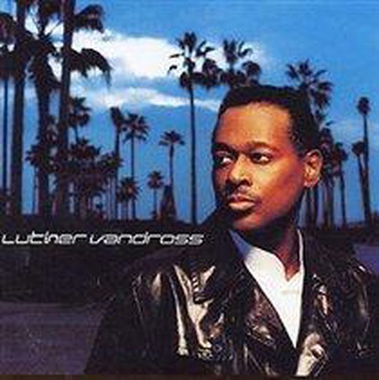 Luther Vandross albumhoes met Luther Vandross die wegkijkt, palmbomen en een blauwe lucht.