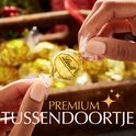 Lindt LINDOR witte chocoladebonbon met goudfolie, vastgehouden tussen twee handen. Premium tussendoortje.