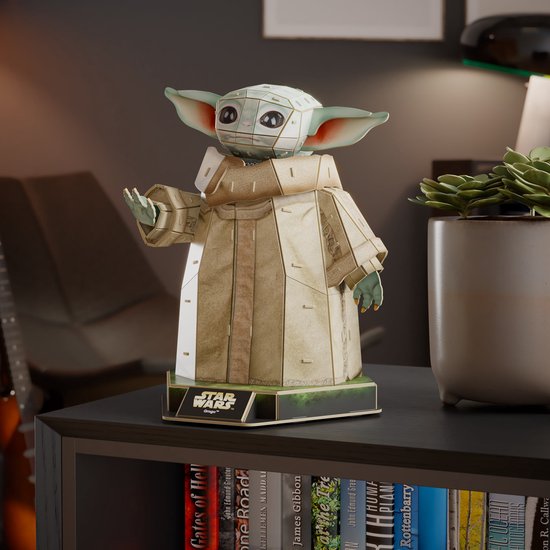 Grogu 3D-puzzel, een beige figuur met grote oren op een boekenplank.