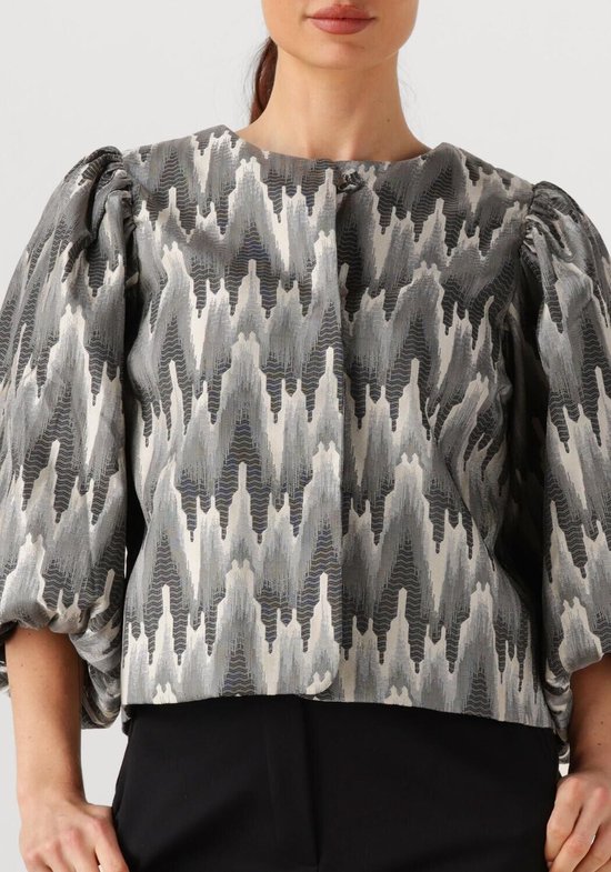 Blouse met volumineuze mouwen en een zigzag patroon in grijs, wit en zwart.